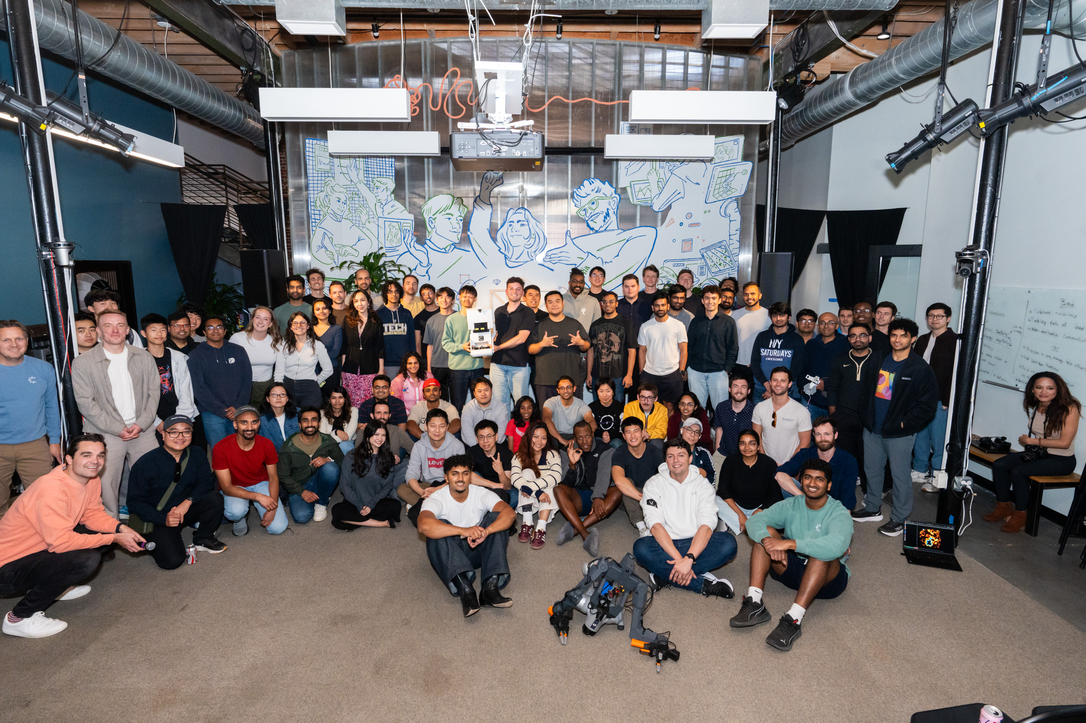 Group photo of everyone at South Park Commons' Embodied AI Hackathon, with MoBot at the front and center